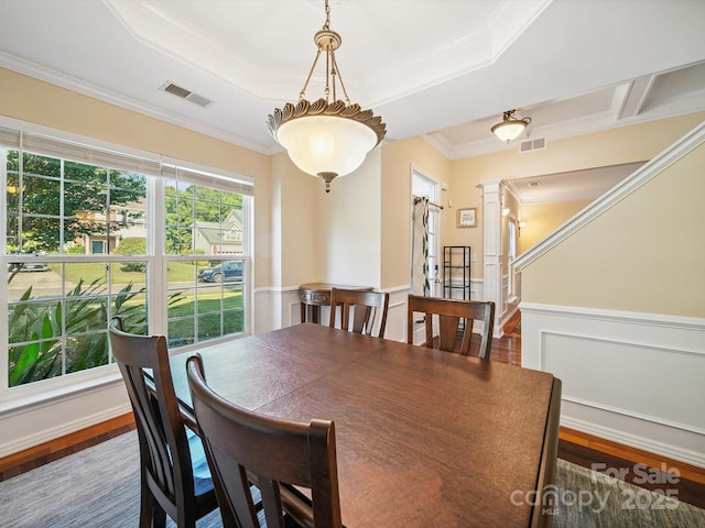 16411 Greybriar Forest Ln, Charlotte, NC 28278 - dining area featuring decorative columns, wood finished floors, crown molding, a tray ceiling, and wainscoting