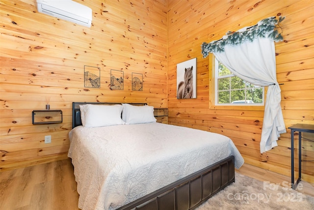 7025 Martin Ln, Morganton, NC 28655 - bedroom featuring an AC wall unit, wood finished floors, and wooden walls