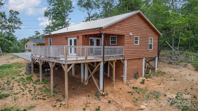7025 Martin Ln, Morganton, NC 28655 - rear view of property with faux log siding, a wooden deck, french doors, and a metal roof