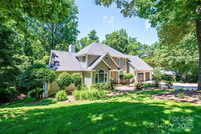 841 16th Avenue Ln NW, Hickory, NC 28601 - view of front facade with a front lawn, a chimney, driveway, and roof with shingles