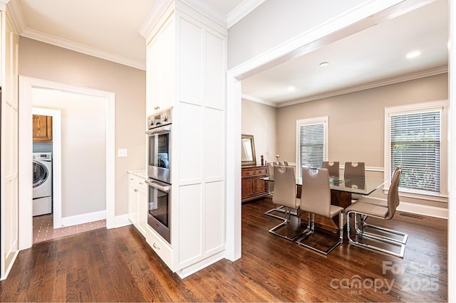 841 16th Avenue Ln NW, Hickory, NC 28601 - kitchen featuring washer / clothes dryer, dark wood-style flooring, double oven, ornamental molding, and white cabinetry