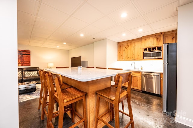 841 16th Avenue Ln NW, Hickory, NC 28601 - kitchen with appliances with stainless steel finishes, concrete floors, recessed lighting, a kitchen breakfast bar, and open floor plan