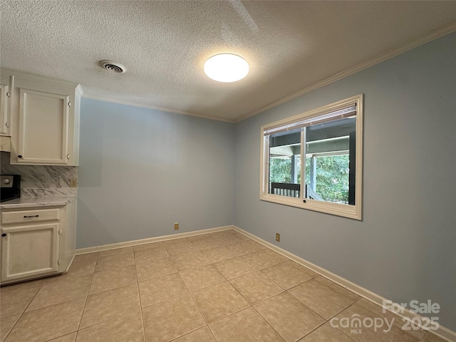 1590 Springpoint Rd Unit B, Rock Hill, SC 29732 - unfurnished dining area featuring ornamental molding, a textured ceiling, and light tile patterned flooring