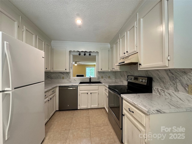 1590 Springpoint Rd Unit B, Rock Hill, SC 29732 - kitchen featuring appliances with stainless steel finishes, under cabinet range hood, backsplash, a textured ceiling, and white cabinetry