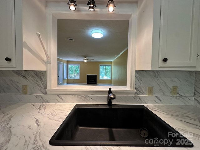 1590 Springpoint Rd Unit B, Rock Hill, SC 29732 - kitchen with decorative backsplash, white cabinets, light stone counters, and a ceiling fan