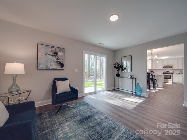 1016 Forest Dr, Marshville, NC 28103 - living area featuring a chandelier and light wood-style floors