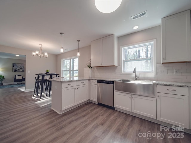 1016 Forest Dr, Marshville, NC 28103 - kitchen featuring dishwasher, a peninsula, wood finished floors, white cabinetry, and recessed lighting