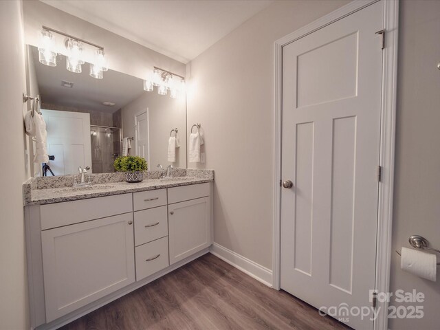 1016 Forest Dr, Marshville, NC 28103 - full bath featuring double vanity, a shower with door, and wood finished floors