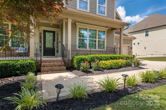 1805 Trading Path Ln, Waxhaw, NC 28173 - doorway to property featuring covered porch, a garage, and driveway