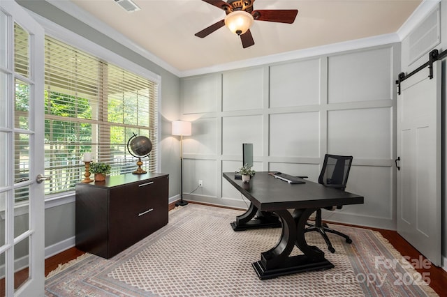 1805 Trading Path Ln, Waxhaw, NC 28173 - office space featuring a decorative wall, a barn door, ceiling fan, wood finished floors, and ornamental molding