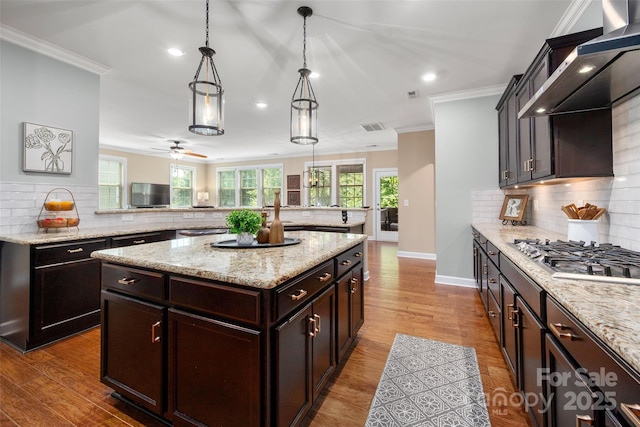 1805 Trading Path Ln, Waxhaw, NC 28173 - kitchen with stainless steel gas cooktop, extractor fan, tasteful backsplash, recessed lighting, and a kitchen island