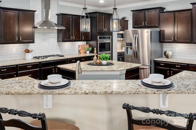 1805 Trading Path Ln, Waxhaw, NC 28173 - kitchen featuring wall chimney range hood, stainless steel appliances, a center island, dark brown cabinetry, and tasteful backsplash