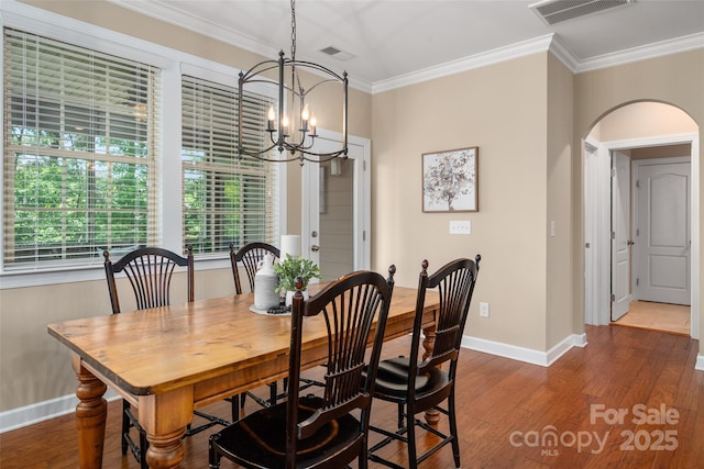1805 Trading Path Ln, Waxhaw, NC 28173 - dining room with arched walkways, crown molding, healthy amount of natural light, wood finished floors, and a chandelier
