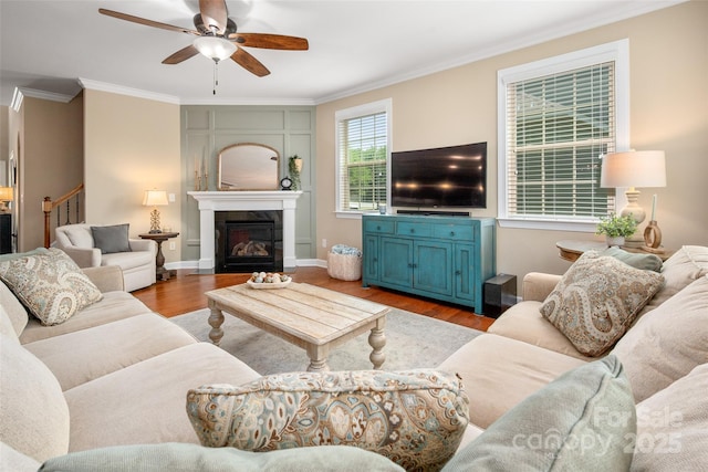 1805 Trading Path Ln, Waxhaw, NC 28173 - living area featuring crown molding, ceiling fan, wood finished floors, a fireplace, and stairs