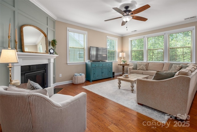1805 Trading Path Ln, Waxhaw, NC 28173 - living room featuring ornamental molding, healthy amount of natural light, a fireplace, wood finished floors, and ceiling fan