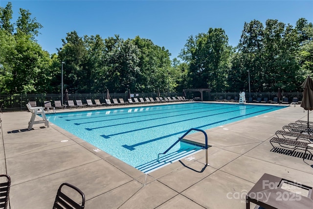 1805 Trading Path Ln, Waxhaw, NC 28173 - community pool featuring a patio and view of wooded area