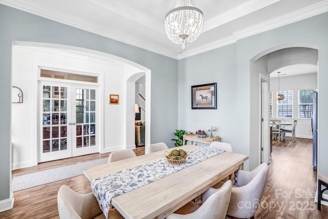 10509 Serape Rd, Charlotte, NC 28277 - dining area with arched walkways, a chandelier, wood finished floors, and ornamental molding