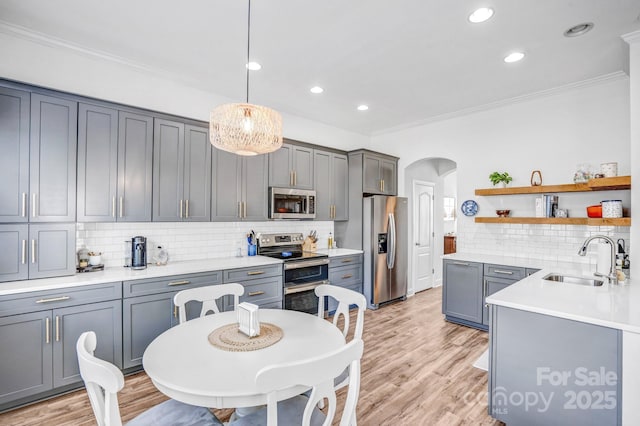 10509 Serape Rd, Charlotte, NC 28277 - kitchen with stainless steel appliances, arched walkways, ornamental molding, tasteful backsplash, and open shelves