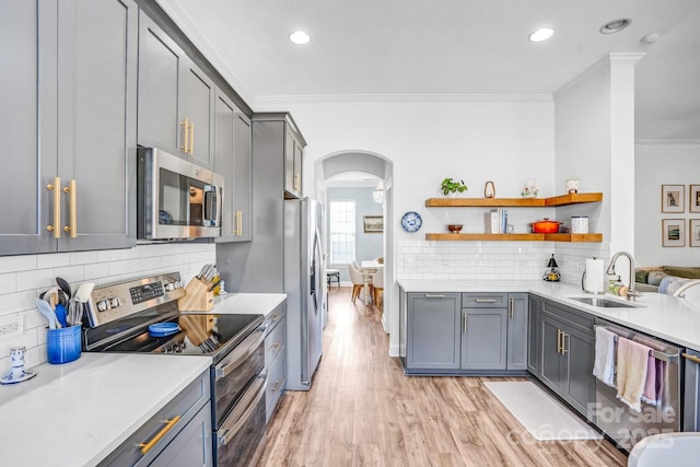 10509 Serape Rd, Charlotte, NC 28277 - kitchen featuring stainless steel appliances, arched walkways, crown molding, decorative backsplash, and light countertops