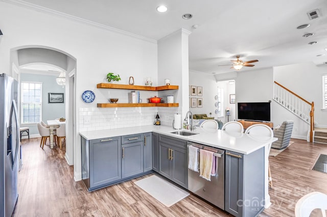 10509 Serape Rd, Charlotte, NC 28277 - kitchen with stainless steel appliances, a peninsula, crown molding, light countertops, and open floor plan