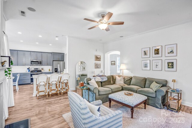 10509 Serape Rd, Charlotte, NC 28277 - living area featuring arched walkways, a ceiling fan, light wood-type flooring, recessed lighting, and ornamental molding