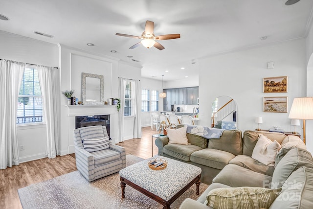 10509 Serape Rd, Charlotte, NC 28277 - living room with healthy amount of natural light, ceiling fan, ornamental molding, a fireplace, and light wood-style floors