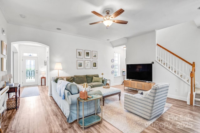 10509 Serape Rd, Charlotte, NC 28277 - living room featuring wood finished floors, plenty of natural light, arched walkways, a ceiling fan, and ornamental molding