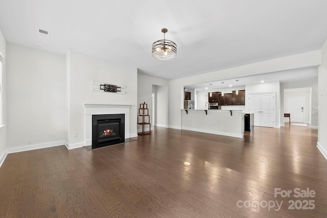 1300 Dali Blvd, Mount Holly, NC 28120 - unfurnished living room featuring a fireplace with flush hearth, dark wood-type flooring, and recessed lighting