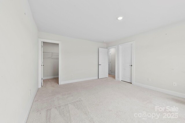 1300 Dali Blvd, Mount Holly, NC 28120 - unfurnished bedroom featuring light carpet, recessed lighting, a walk in closet, and a closet