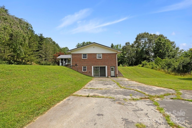 100 Nimitz Dr, Brevard, NC 28712 - back of house featuring brick siding, a yard, and asphalt driveway