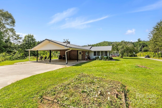 100 Nimitz Dr, Brevard, NC 28712 - view of front facade with an attached carport, a front lawn, brick siding, and concrete driveway