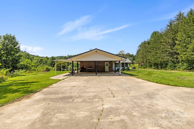 100 Nimitz Dr, Brevard, NC 28712 - view of front facade with concrete driveway, a front yard, brick siding, and a carport
