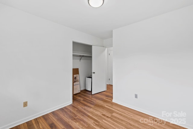 100 Nimitz Dr, Brevard, NC 28712 - unfurnished bedroom featuring wood finished floors, a closet, and washer / dryer