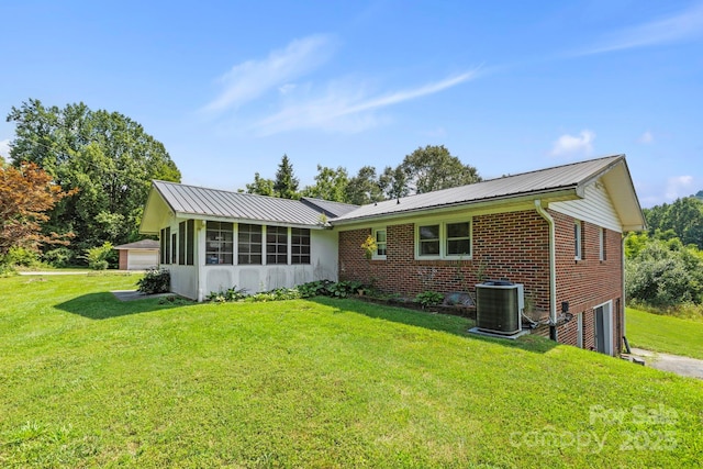 100 Nimitz Dr, Brevard, NC 28712 - back of property with a lawn, brick siding, a metal roof, a sunroom, and a garage