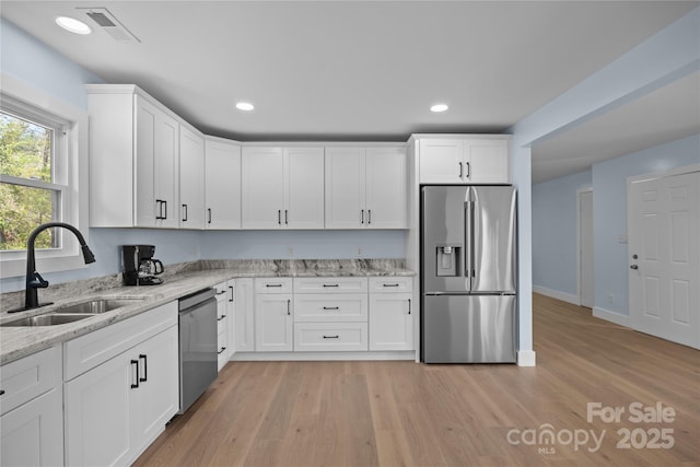 221 John C Logan Rd, Rutherfordton, NC 28139 - kitchen with stainless steel appliances, light wood-type flooring, white cabinets, light stone counters, and recessed lighting