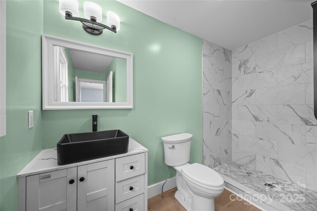221 John C Logan Rd, Rutherfordton, NC 28139 - full bath featuring vanity, a tile shower, and wood finished floors