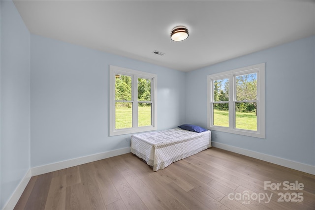 221 John C Logan Rd, Rutherfordton, NC 28139 - bedroom with multiple windows and wood finished floors