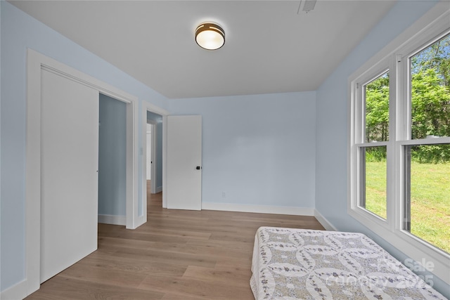 221 John C Logan Rd, Rutherfordton, NC 28139 - unfurnished bedroom with baseboards and wood finished floors