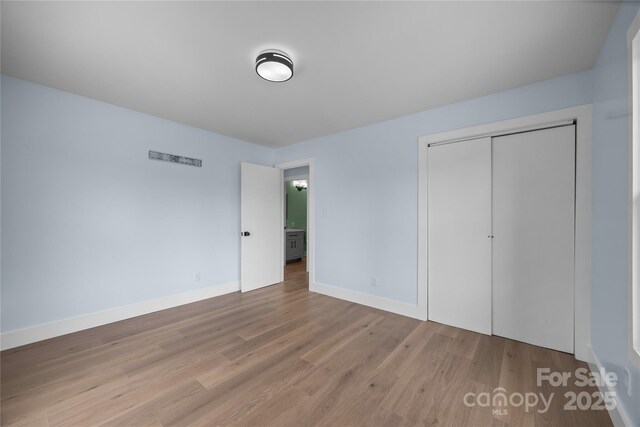 221 John C Logan Rd, Rutherfordton, NC 28139 - unfurnished bedroom featuring wood finished floors and a closet