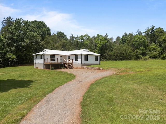 221 John C Logan Rd, Rutherfordton, NC 28139 - manufactured / mobile home with driveway, a front lawn, a wooden deck, stairs, and crawl space