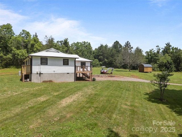 221 John C Logan Rd, Rutherfordton, NC 28139 - view of green lawn featuring a storage shed, stairs, dirt driveway, and a deck