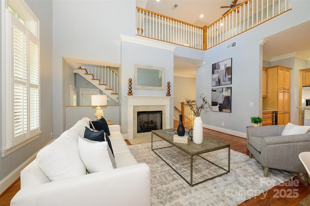 6312 Mission Pl, Charlotte, NC 28210 - living area with a towering ceiling, plenty of natural light, wood finished floors, a ceiling fan, and stairway