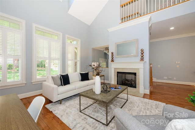 6312 Mission Pl, Charlotte, NC 28210 - living room featuring a fireplace, wood finished floors, high vaulted ceiling, and crown molding