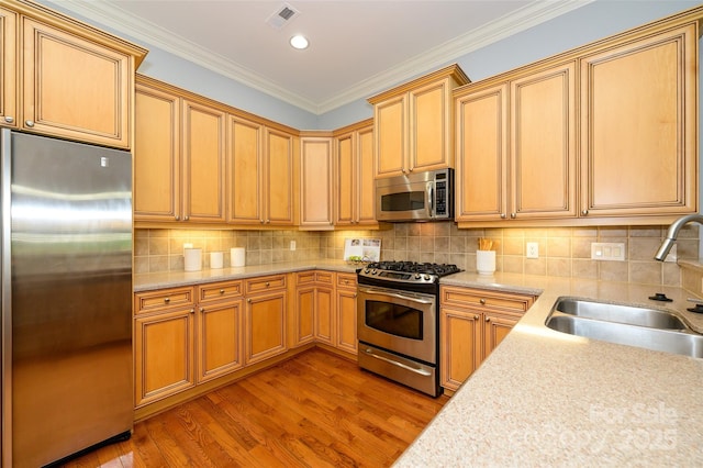 6312 Mission Pl, Charlotte, NC 28210 - kitchen with appliances with stainless steel finishes, wood finished floors, backsplash, crown molding, and recessed lighting