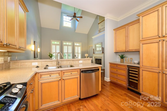 6312 Mission Pl, Charlotte, NC 28210 - kitchen with beverage cooler, stainless steel appliances, ceiling fan, a peninsula, and light wood-style floors