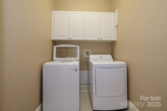 6312 Mission Pl, Charlotte, NC 28210 - washroom with cabinet space, separate washer and dryer, and light tile patterned floors