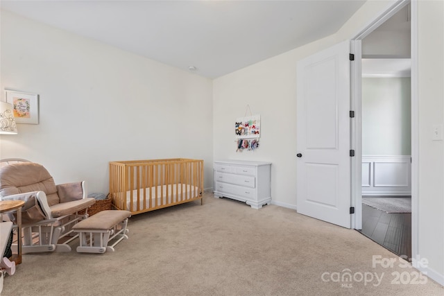 9547 Horsebit Ln, Concord, NC 28027 - bedroom with carpet floors, a nursery area, and a wainscoted wall