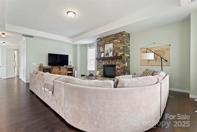 9547 Horsebit Ln, Concord, NC 28027 - living area featuring a raised ceiling, dark wood finished floors, and a stone fireplace