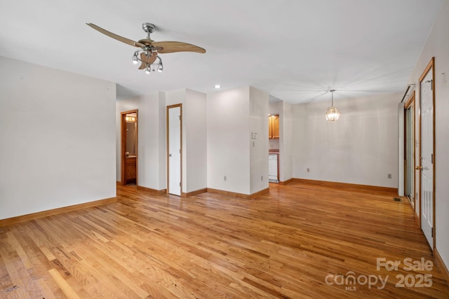 55 Wyatt St, Asheville, NC 28803 - spare room with light wood-style flooring, ceiling fan, and a chandelier