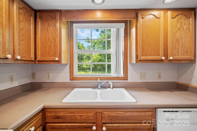 55 Wyatt St, Asheville, NC 28803 - kitchen featuring dishwasher, plenty of natural light, light countertops, and brown cabinetry